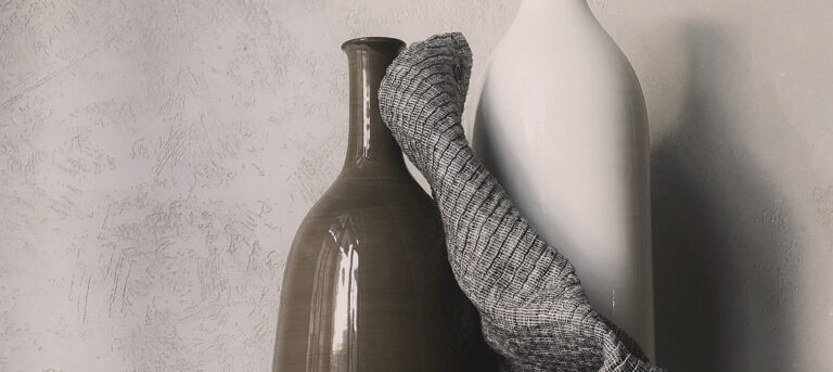 A vase and a sock on the wall