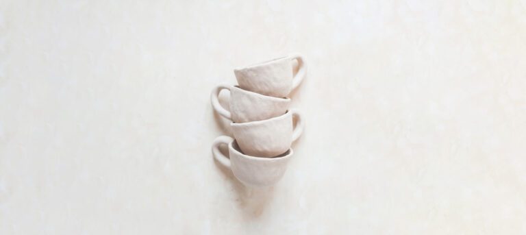 A group of four cups that are stacked on top of each other.