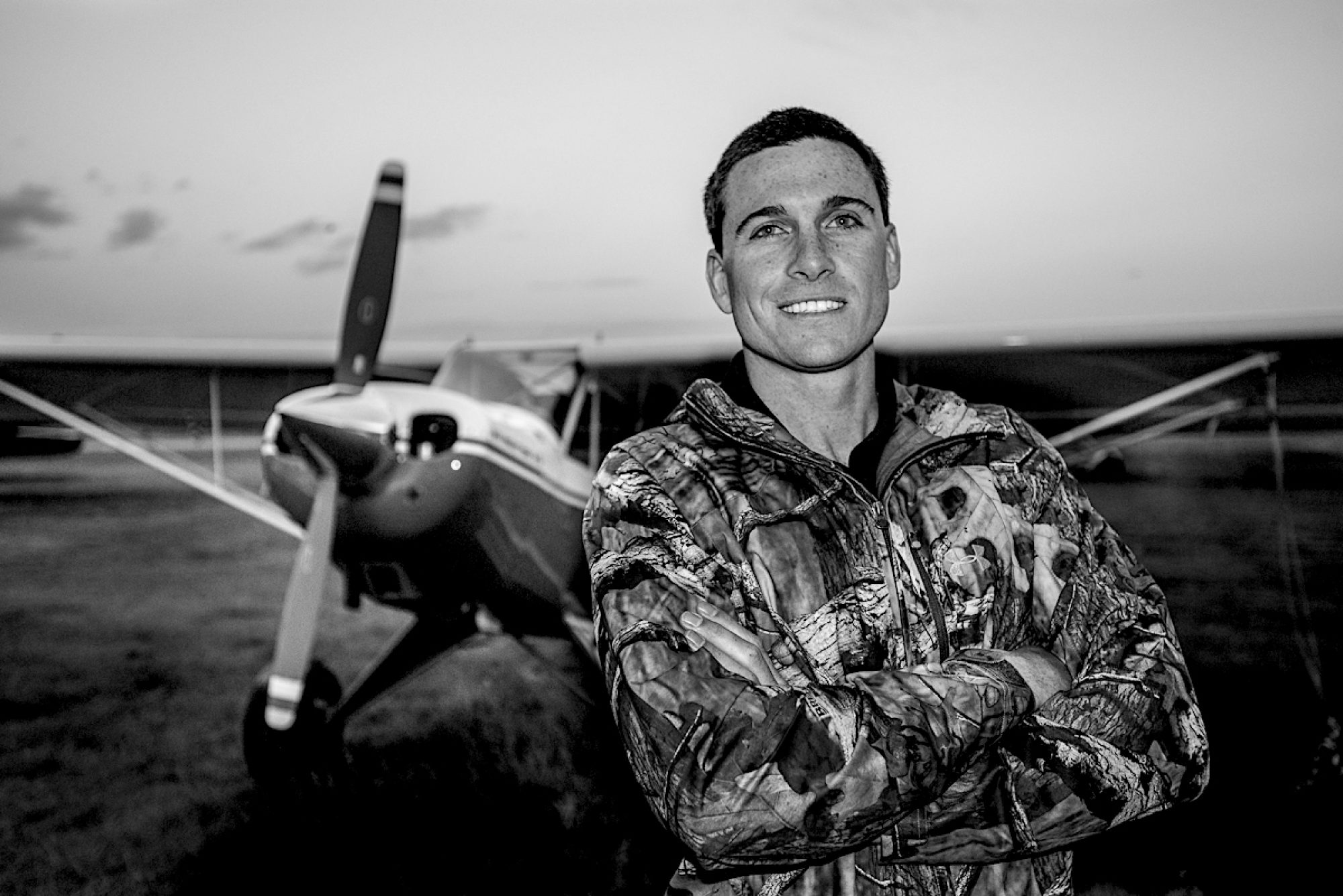 A man standing in front of an airplane.