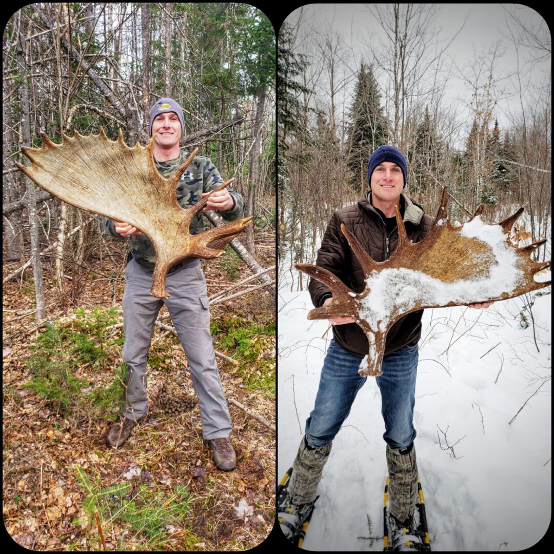 Two men holding large moose antlers.