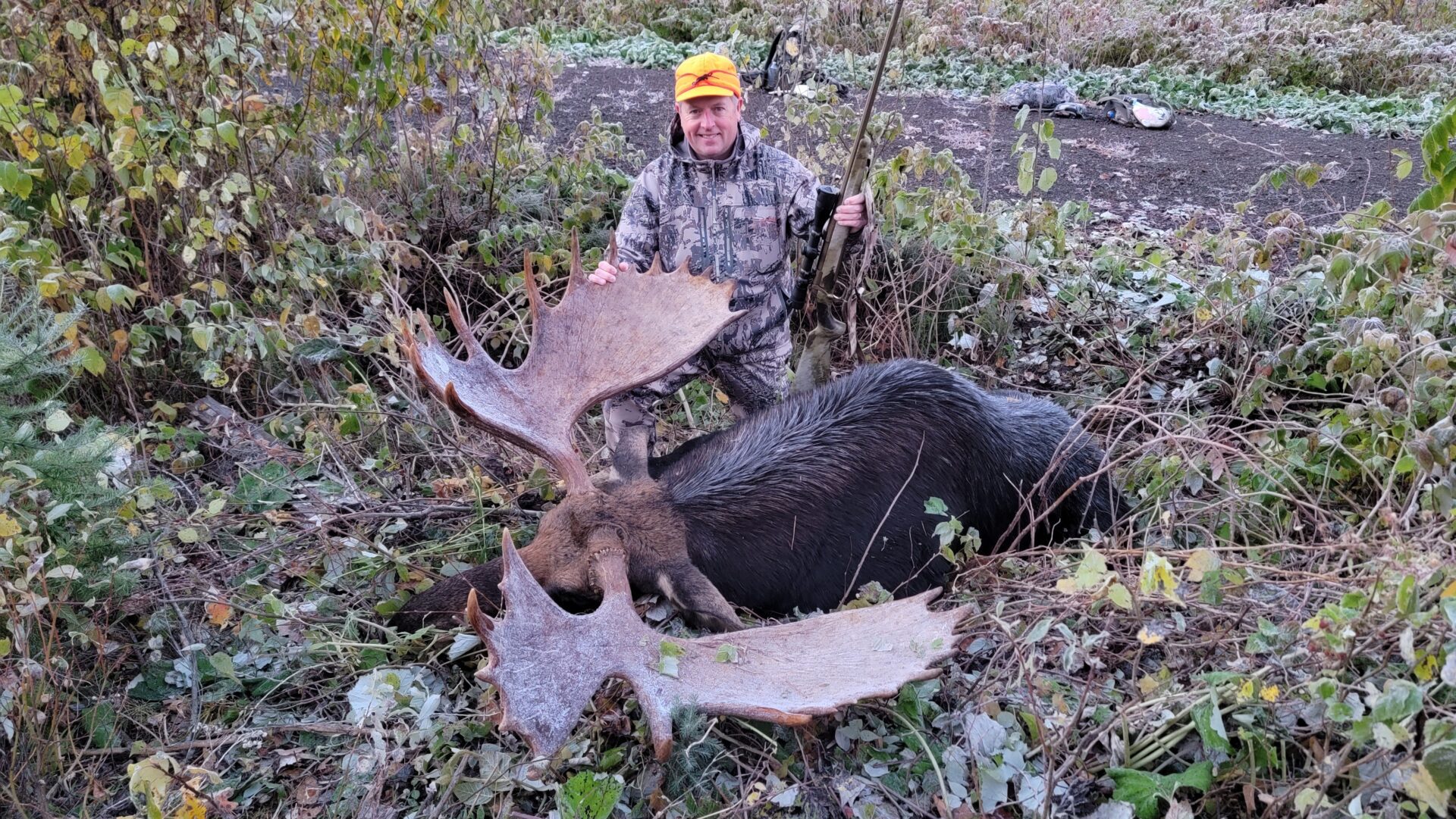 Hunter poses with a harvested moose.