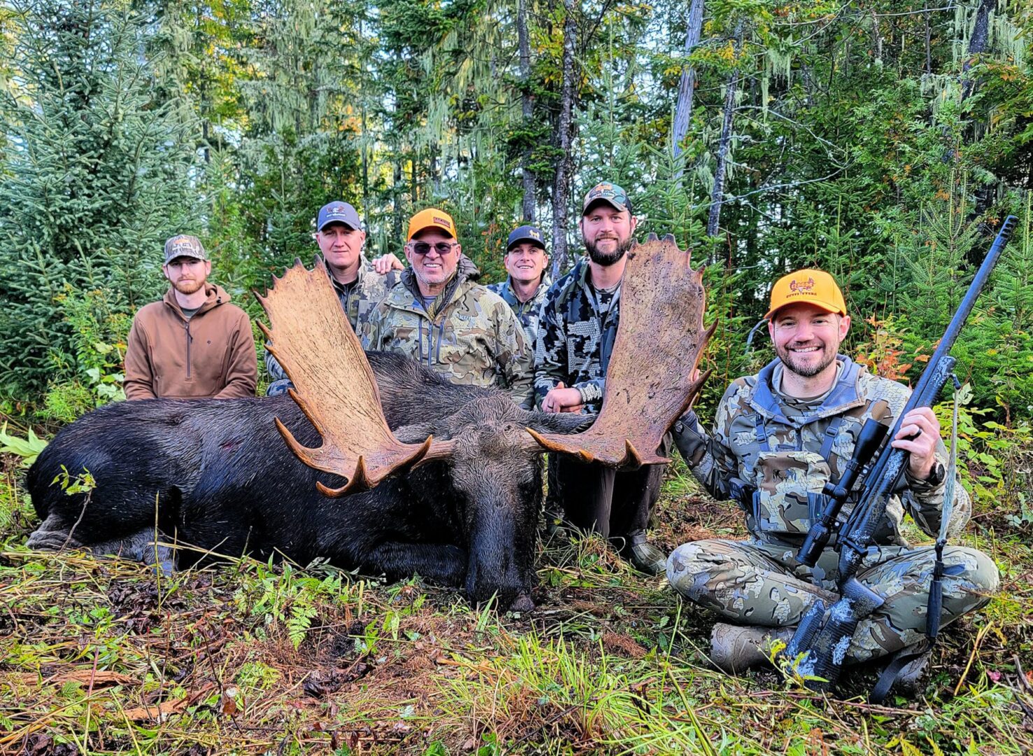 Group of hunters with a harvested moose.